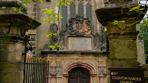 A close-up image of the entrance to Staunton Harold Church in Leicestershire, with an inscription dedicated to Sir Robert Shirley visible above the entrance